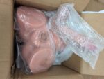 Actual XISE Gretel Local Stock unit in shipping box with tan lower-body torso and detachable attachment in protective wrapping