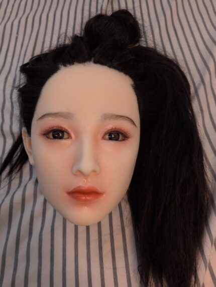 Hana hard silicone doll head with implanted black hair, front view